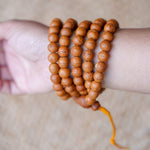 High Quality Bodhi Mala being worn around wrist aerial view