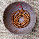 Products 14 mm Bodhi Bead being kept on a copper bowl.