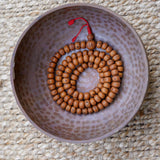 Products 14 mm Bodhi Bead being kept on a copper bowl.