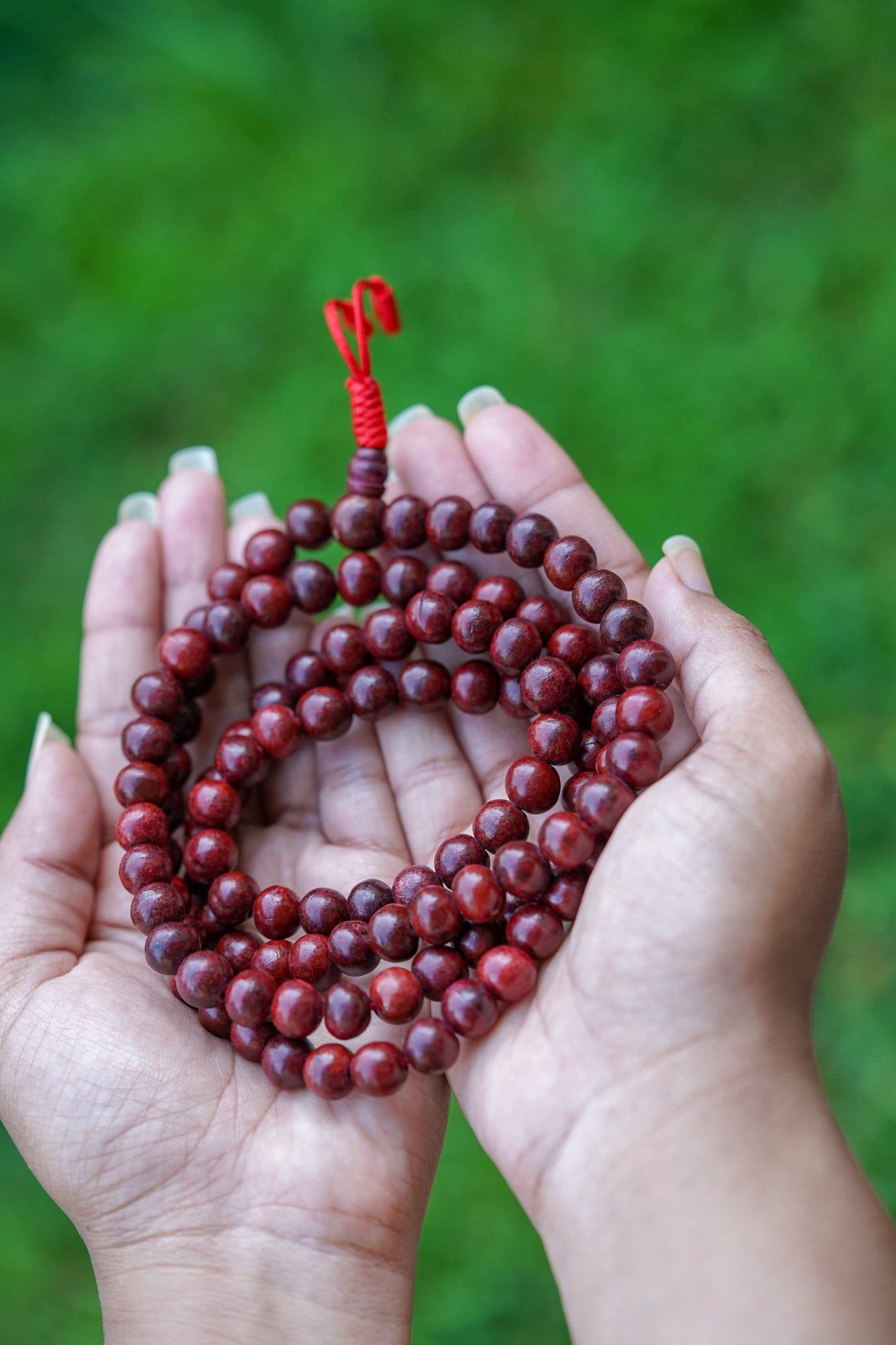 Rosewood Mala being held