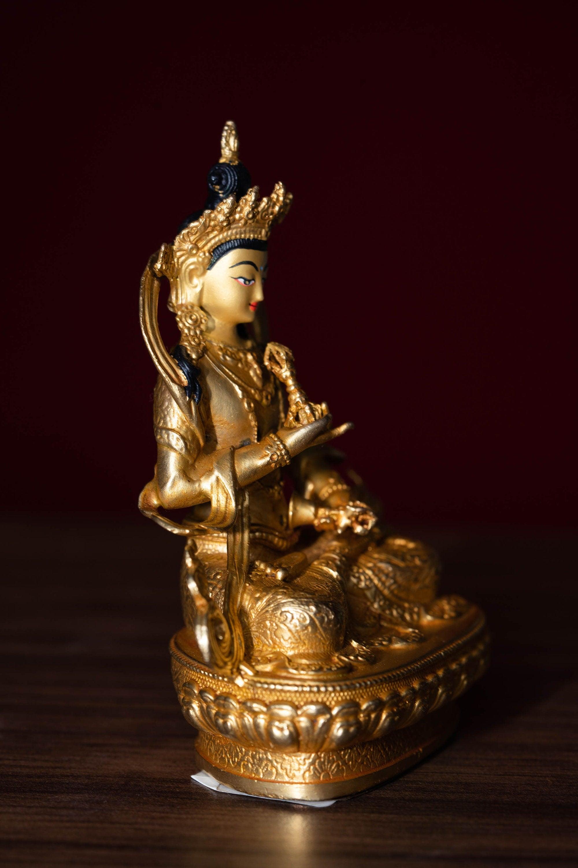 Vajrasattva holds the Vajra in his hand and seated on lotus. This is gold plated small size statue of Buddhist deity