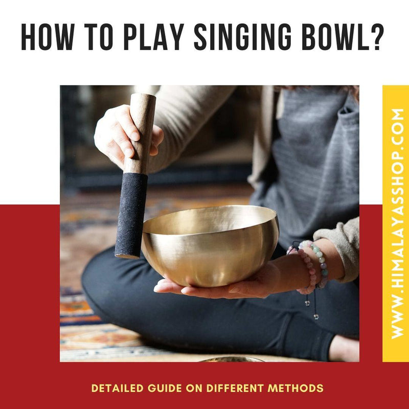 Playing a singing bowl with a wooden mallet