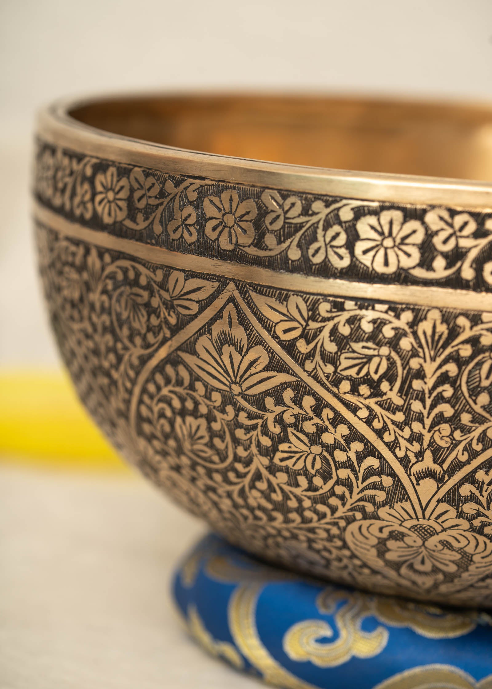 Lotus Floral Engraved handmade Tibetan singing bowl with brass carving, wooden mallet, and cushion for meditation and chakra healing