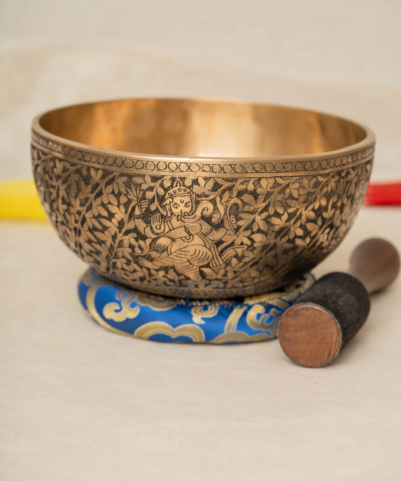 Handmade Himalayan Ganesha engraved brass singing bowl tuned to F3 and C5 for throat and heart chakra sound healing