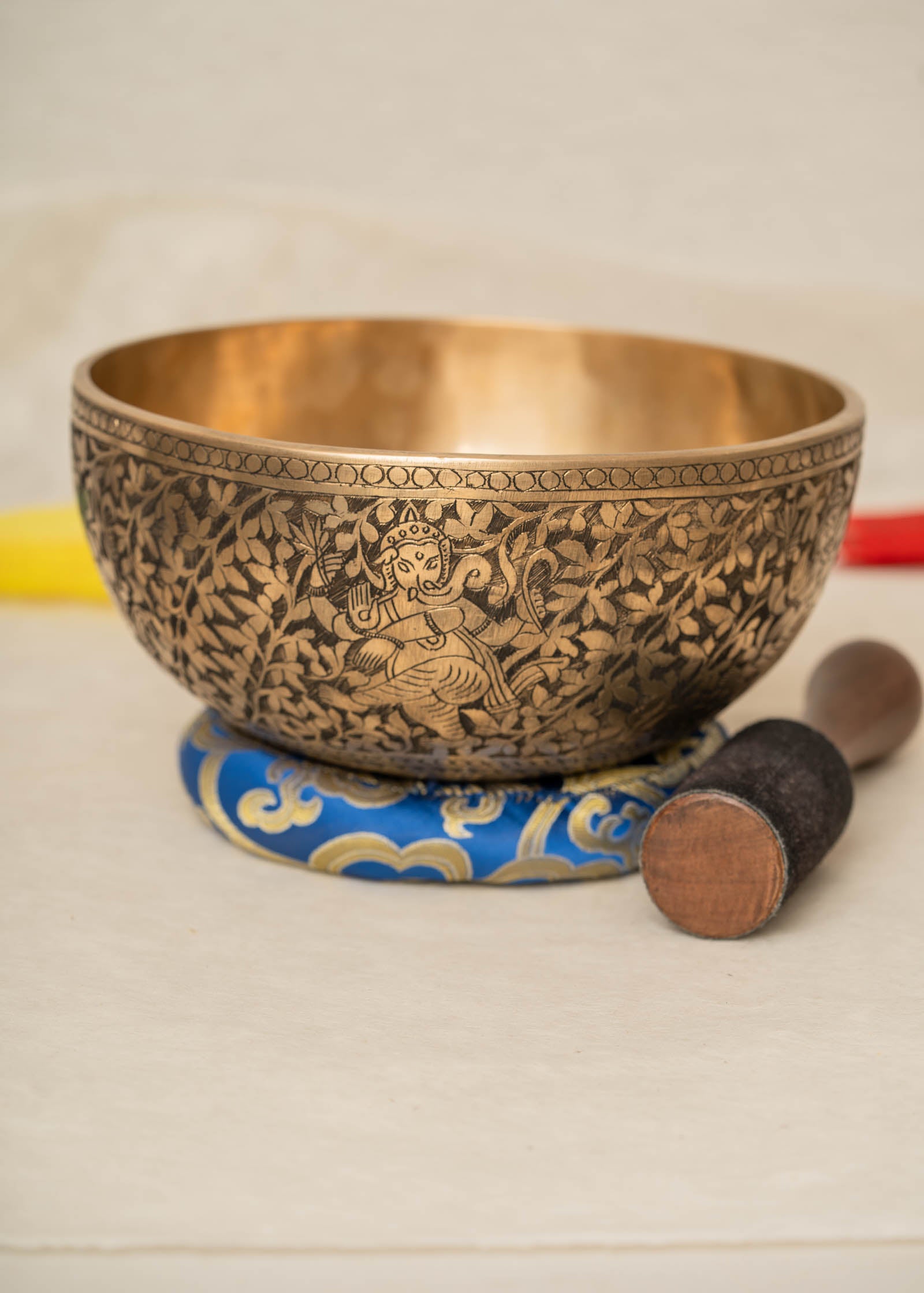 Handmade Himalayan Ganesha engraved brass singing bowl tuned to F3 and C5 for throat and heart chakra sound healing