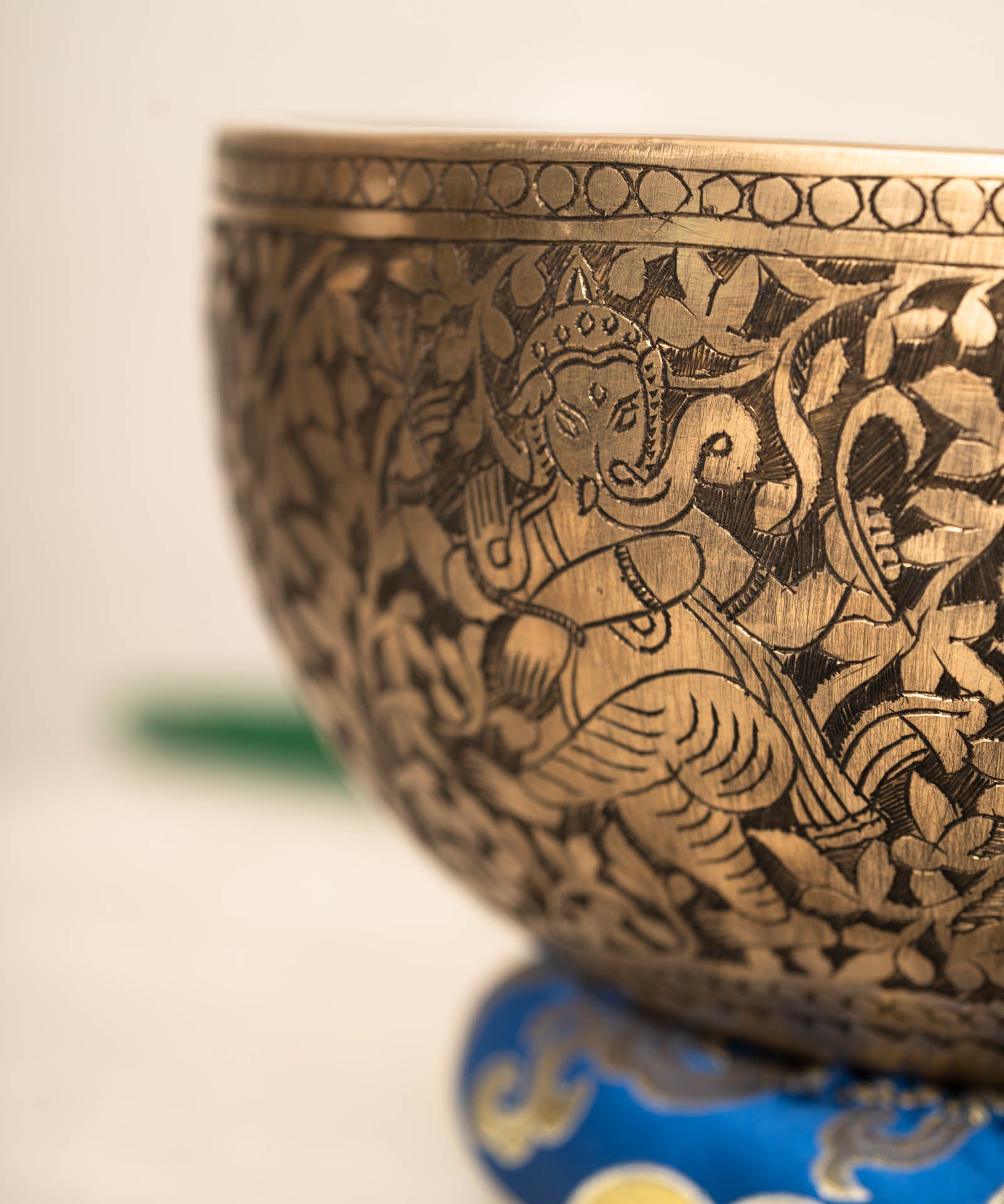 Handmade Himalayan Ganesha engraved brass singing bowl tuned to F3 and C5 for throat and heart chakra sound healing
