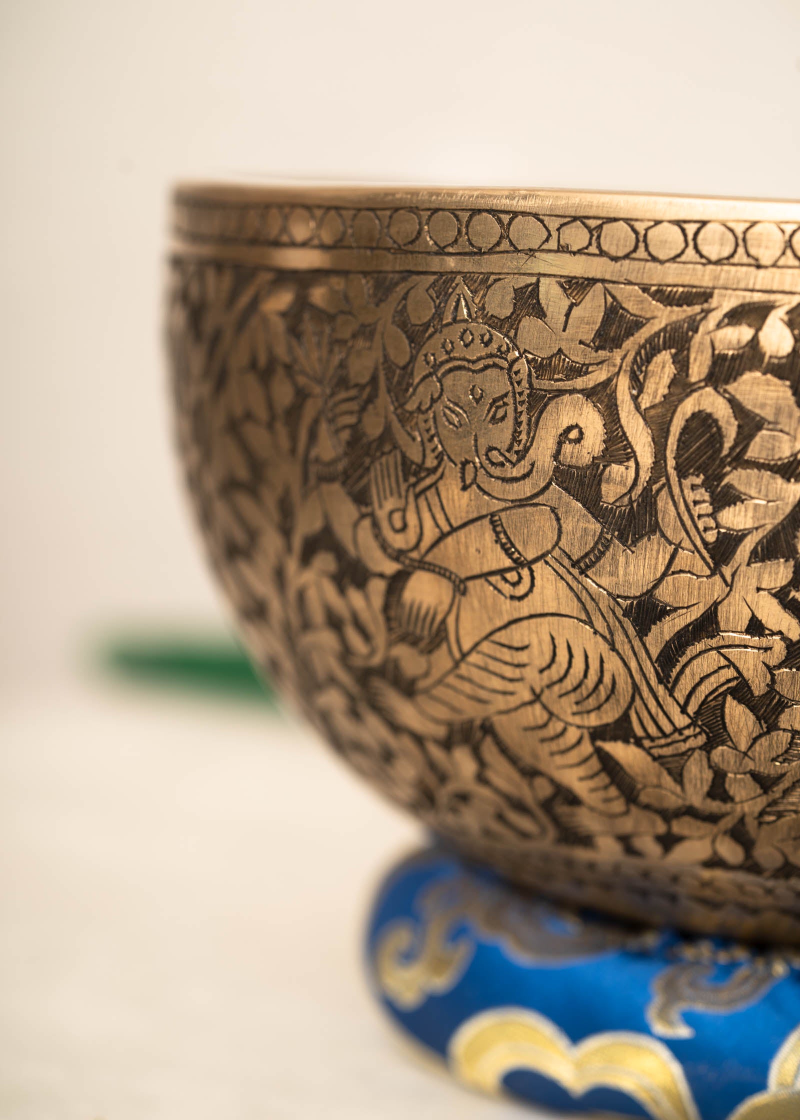 Handmade Himalayan Ganesha engraved brass singing bowl tuned to F3 and C5 for throat and heart chakra sound healing