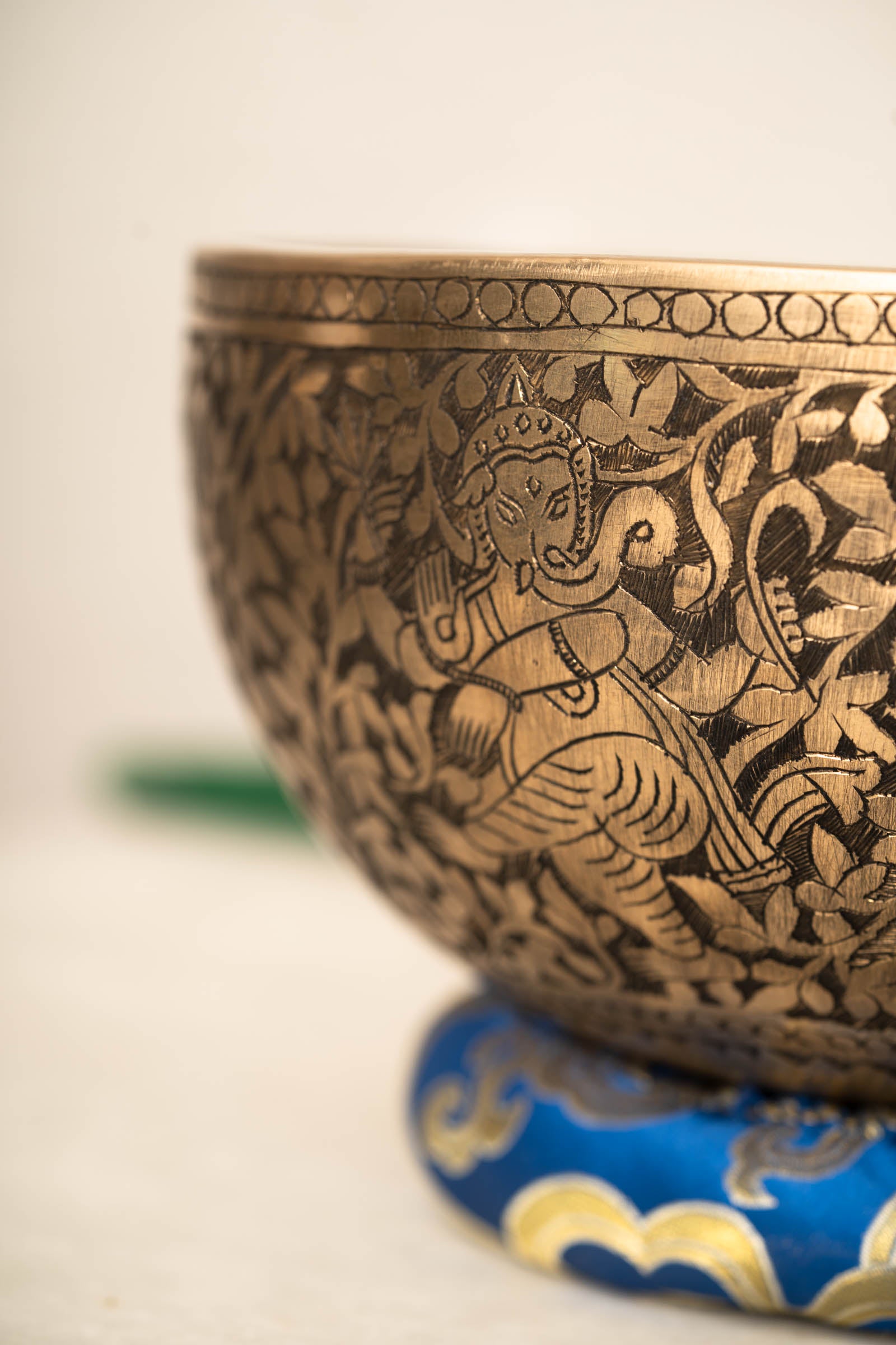Handmade Himalayan Ganesha engraved brass singing bowl tuned to F3 and C5 for throat and heart chakra sound healing