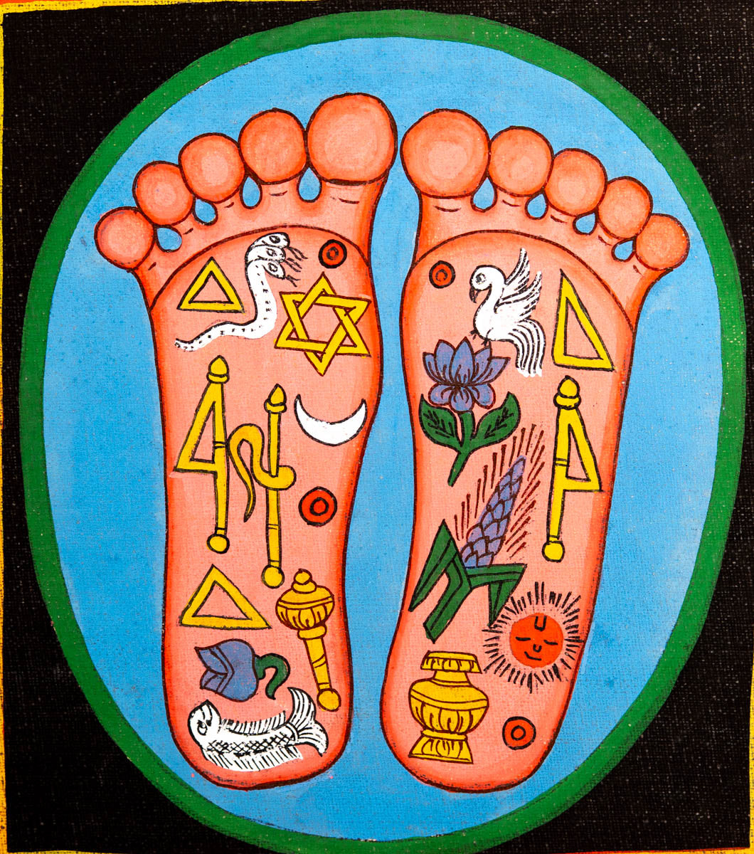Painting of two sacred feet with colorful spiritual symbols 