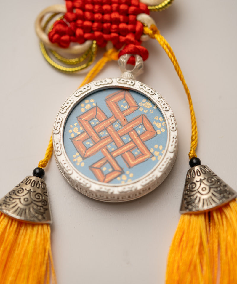 Tassel-Adorned Endless Knot Locket
