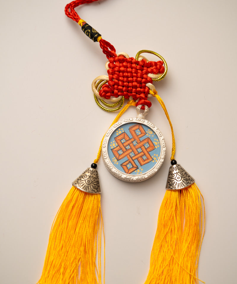 Tassel-Adorned Endless Knot Locket