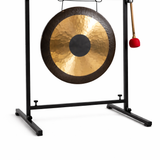 Hand made Gong on a stand with a red mallet on a white background