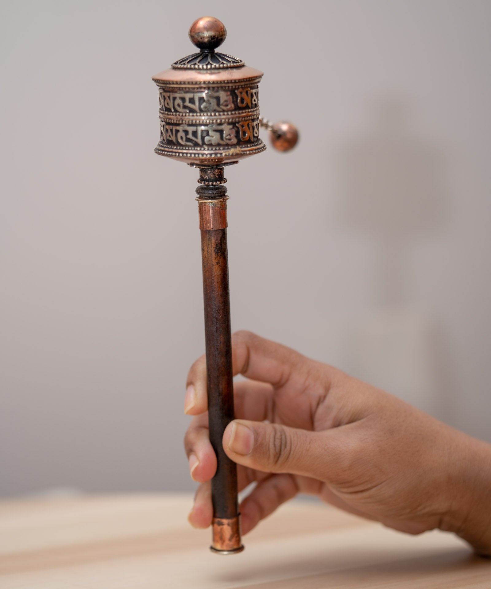 Wood handle prayer wheel for spiritual and religious routines.