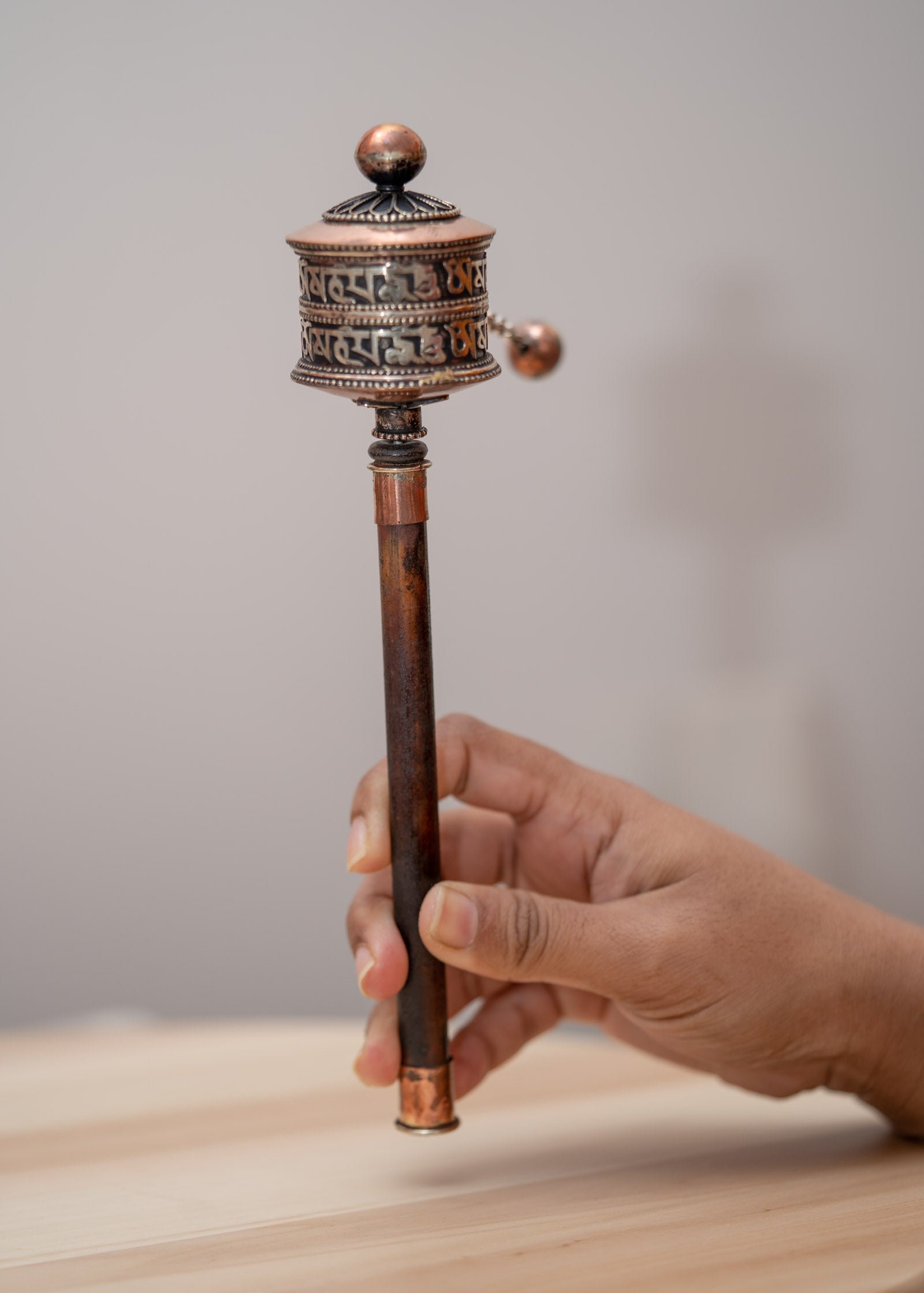 Wood handle prayer wheel for spiritual and religious routines.
