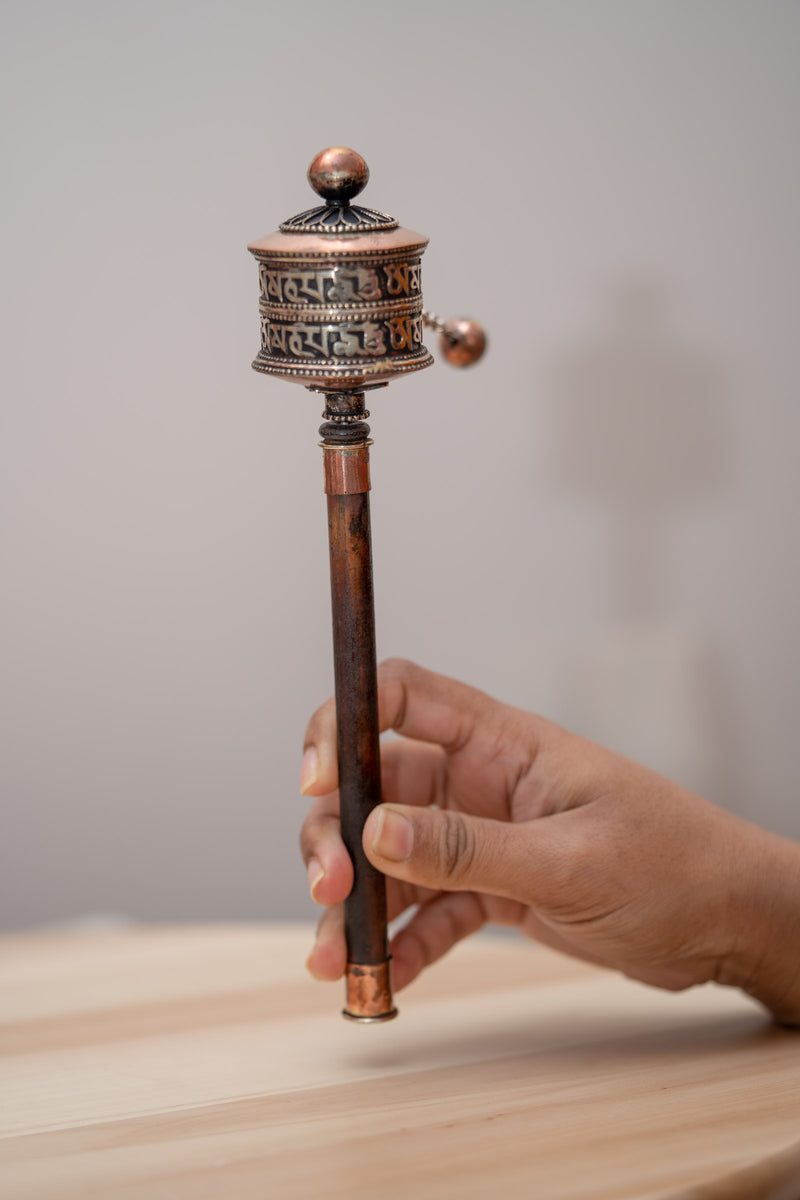 Wood handle prayer wheel for spiritual and religious routines.