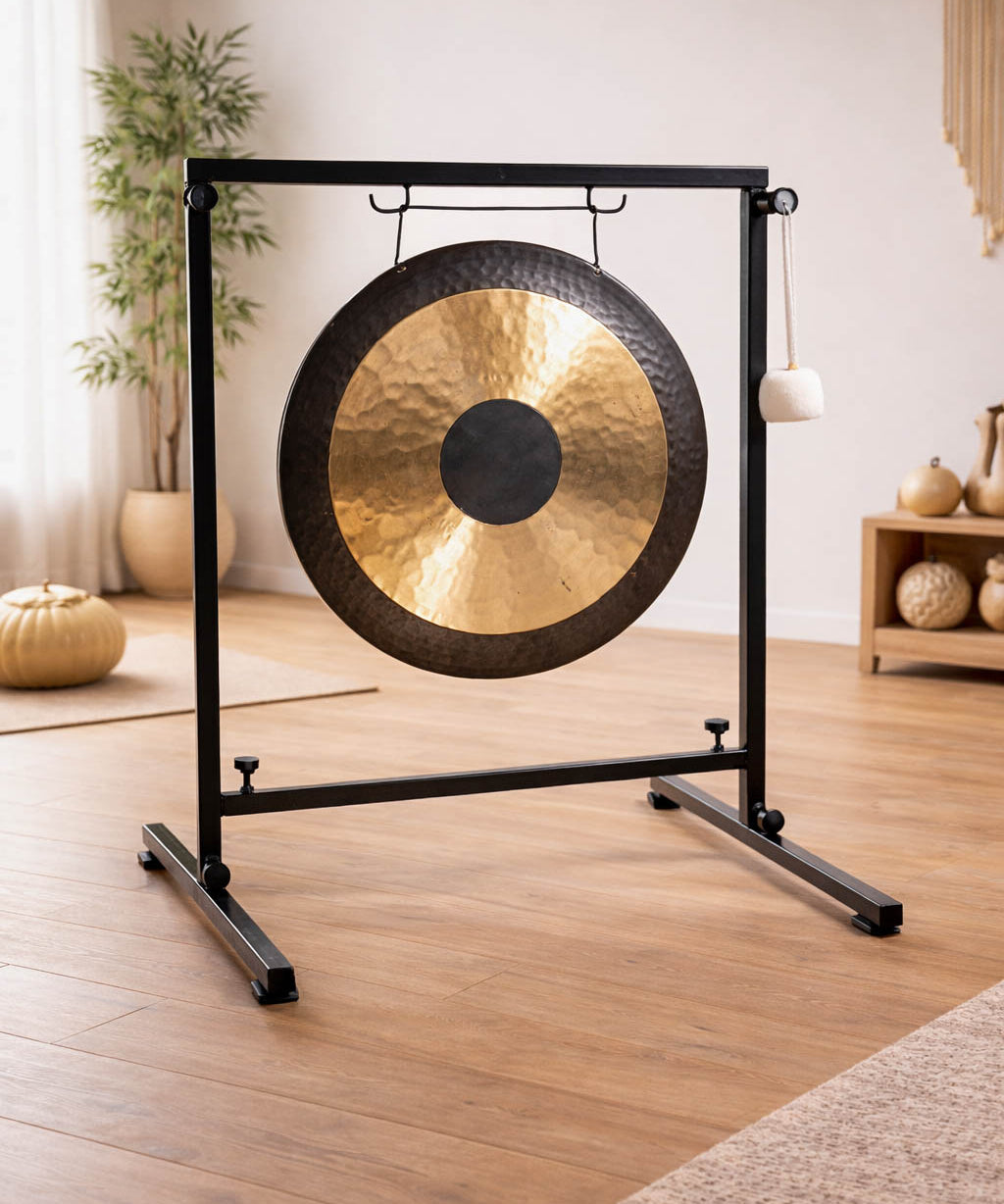 Gong on a stand in a room with wooden floor and decor