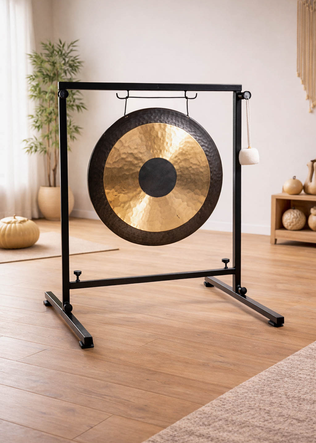 Gong on a stand in a room with wooden floor and decor