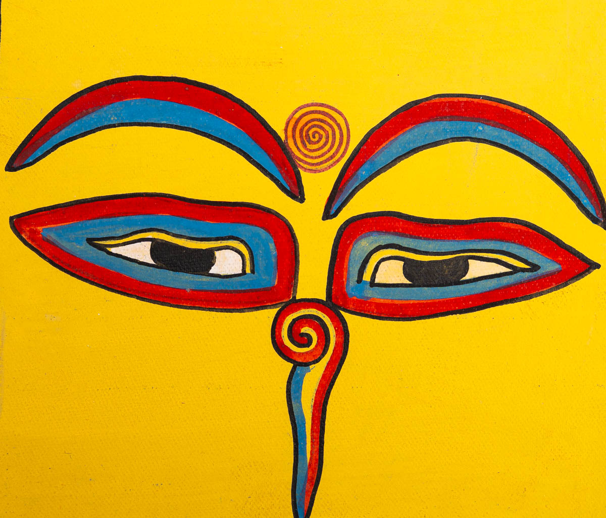 Hand-painted sacred eyes spiral symbols on the forehead and nose, representing wisdom and spiritual awareness.