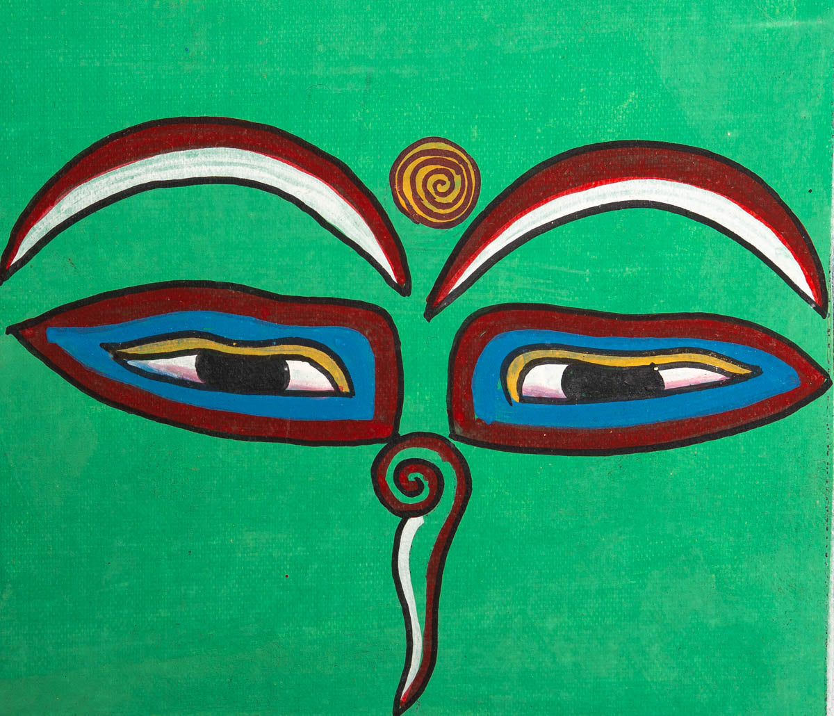 Hand-painted sacred eyes spiral symbols on the forehead and nose, representing wisdom and spiritual awareness.