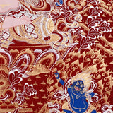 Chenrezig Thangka painting with red background, Avalokiteshvara seated on lotus throne, and traditional Tibetan Buddhist compassion symbolism.