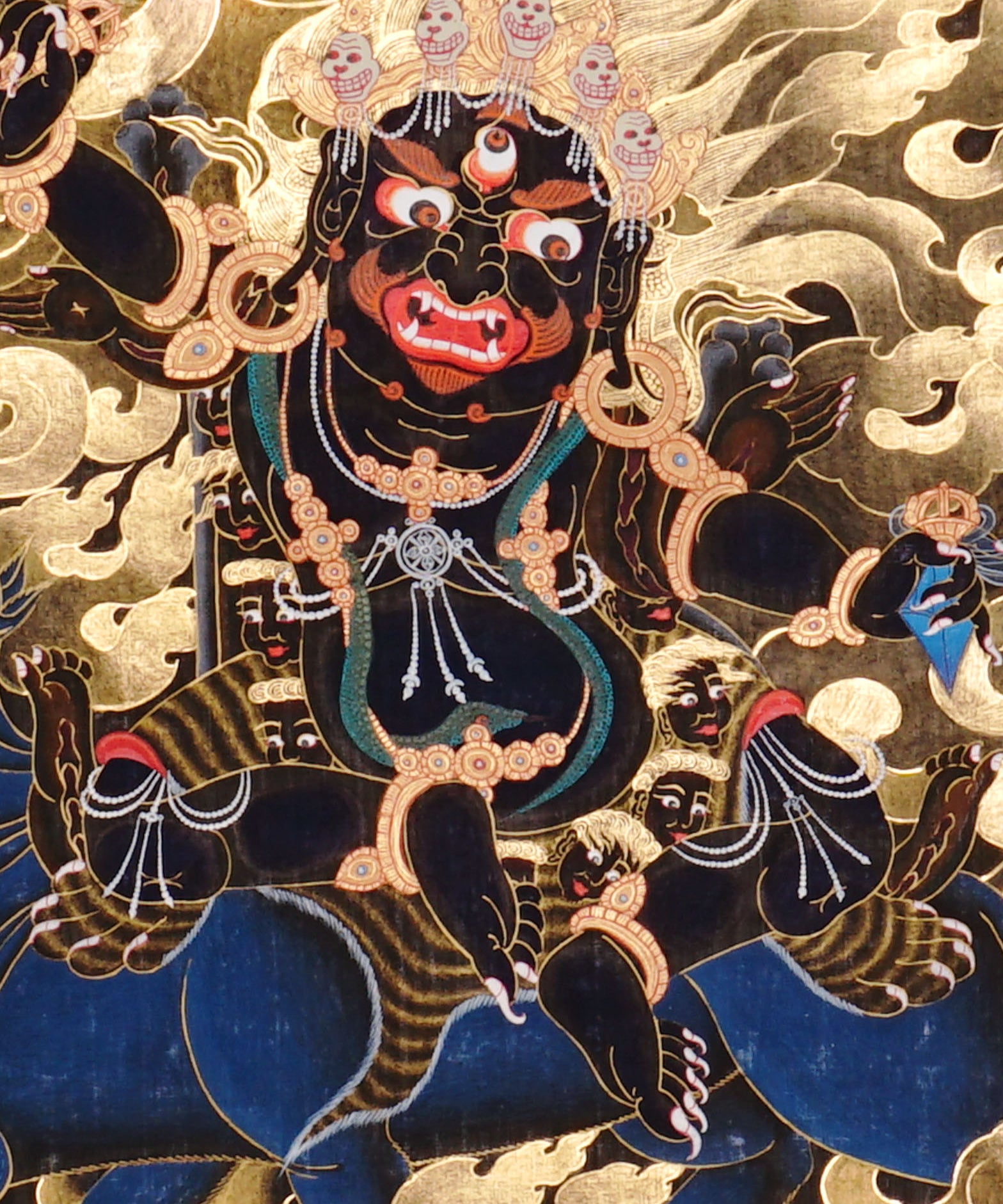 Vajra Guru Thangka Painting showing a wrathful Tibetan Buddhist protector deity riding a fierce blue mount, surrounded by flame aura, golden clouds, skull crown, sacred ornaments, lotus base and offering details.