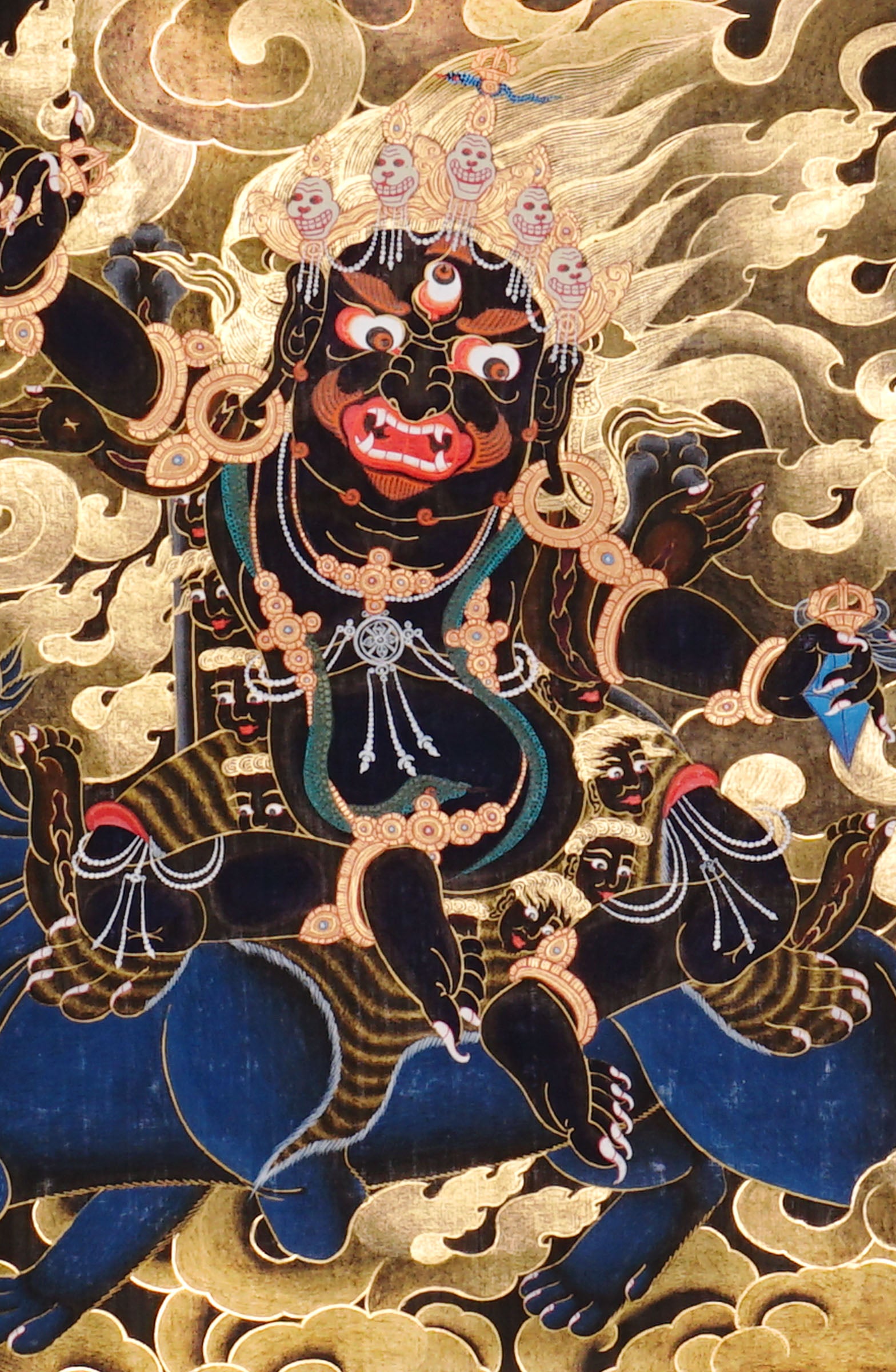 Vajra Guru Thangka Painting showing a wrathful Tibetan Buddhist protector deity riding a fierce blue mount, surrounded by flame aura, golden clouds, skull crown, sacred ornaments, lotus base and offering details.