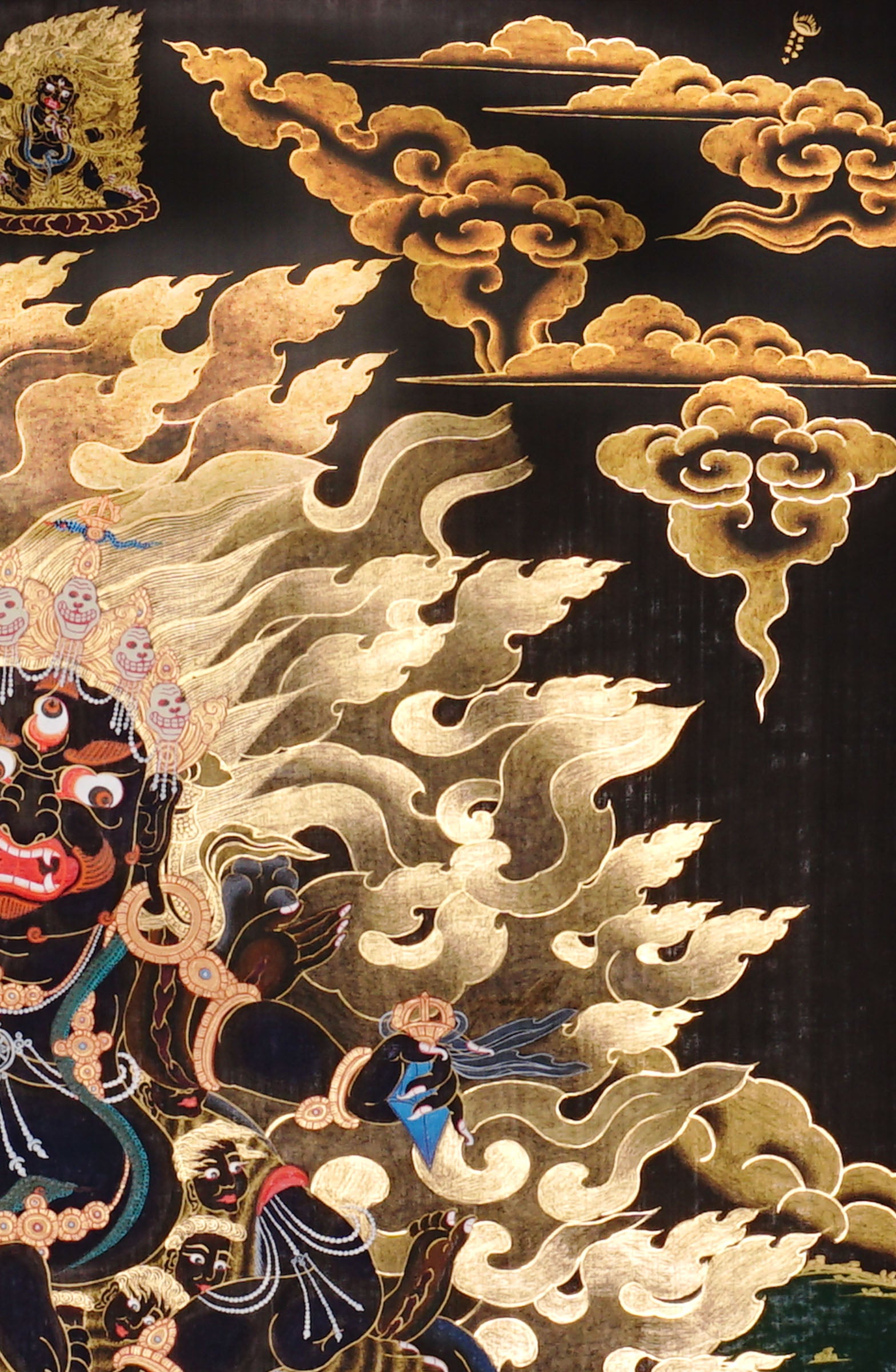 Vajra Guru Thangka Painting showing a wrathful Tibetan Buddhist protector deity riding a fierce blue mount, surrounded by flame aura, golden clouds, skull crown, sacred ornaments, lotus base and offering details.