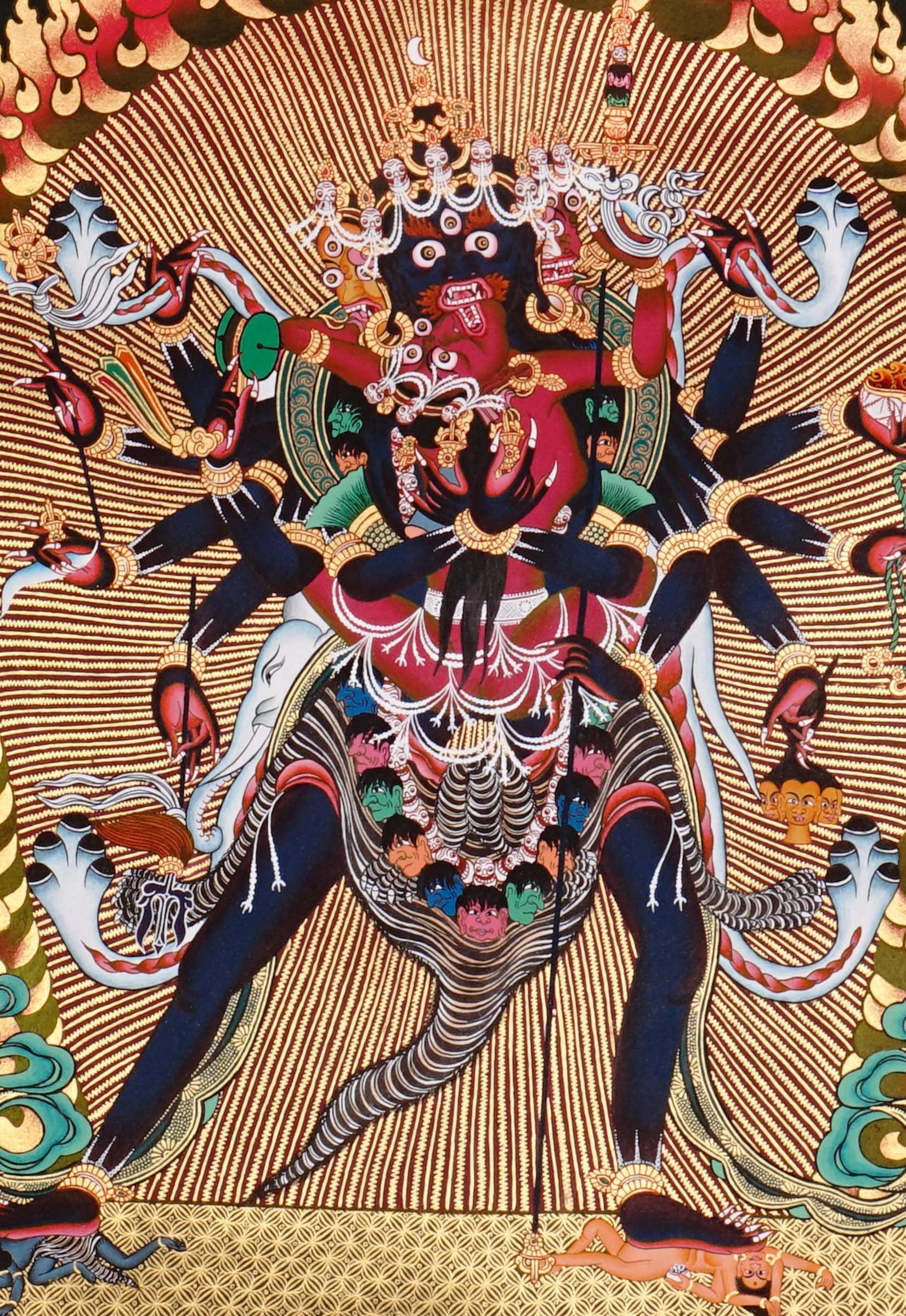 Chakrasambhara Thangka Painting showing in a wrathful form with multiple arms, flame aura, skull ornaments, sacred implements, lotus base and Himalayan landscape details.