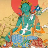 Green Tara Thangka painting with lotus throne, blue utpala flower, serene landscape, and Tibetan Buddhist compassion symbolism.