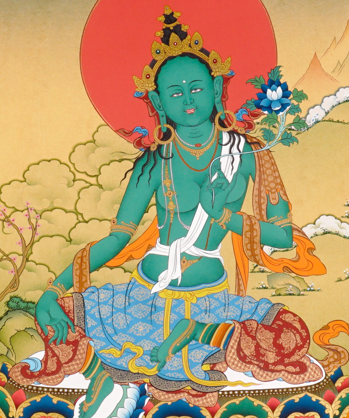 Green Tara Thangka painting with lotus throne, blue utpala flower, serene landscape, and Tibetan Buddhist compassion symbolism.