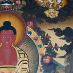 Framed Amitabha Thangka Painting showing Amitabha Buddha seated on a lotus throne in meditation posture with alms bowl, radiant halo, surrounding deity figures, offering symbols, clouds, flowers, water and Himalayan landscape details.