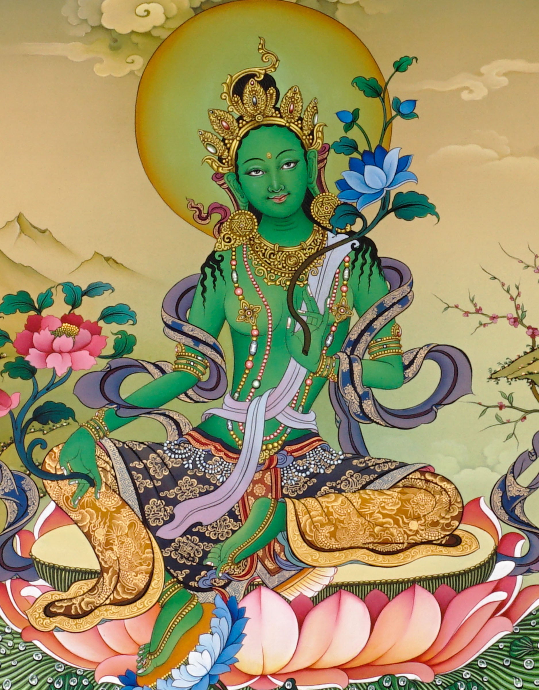 Green Tara thangka painting Tibetan goddess seated on lotus holding blue lotus in detailed Himalayan landscape