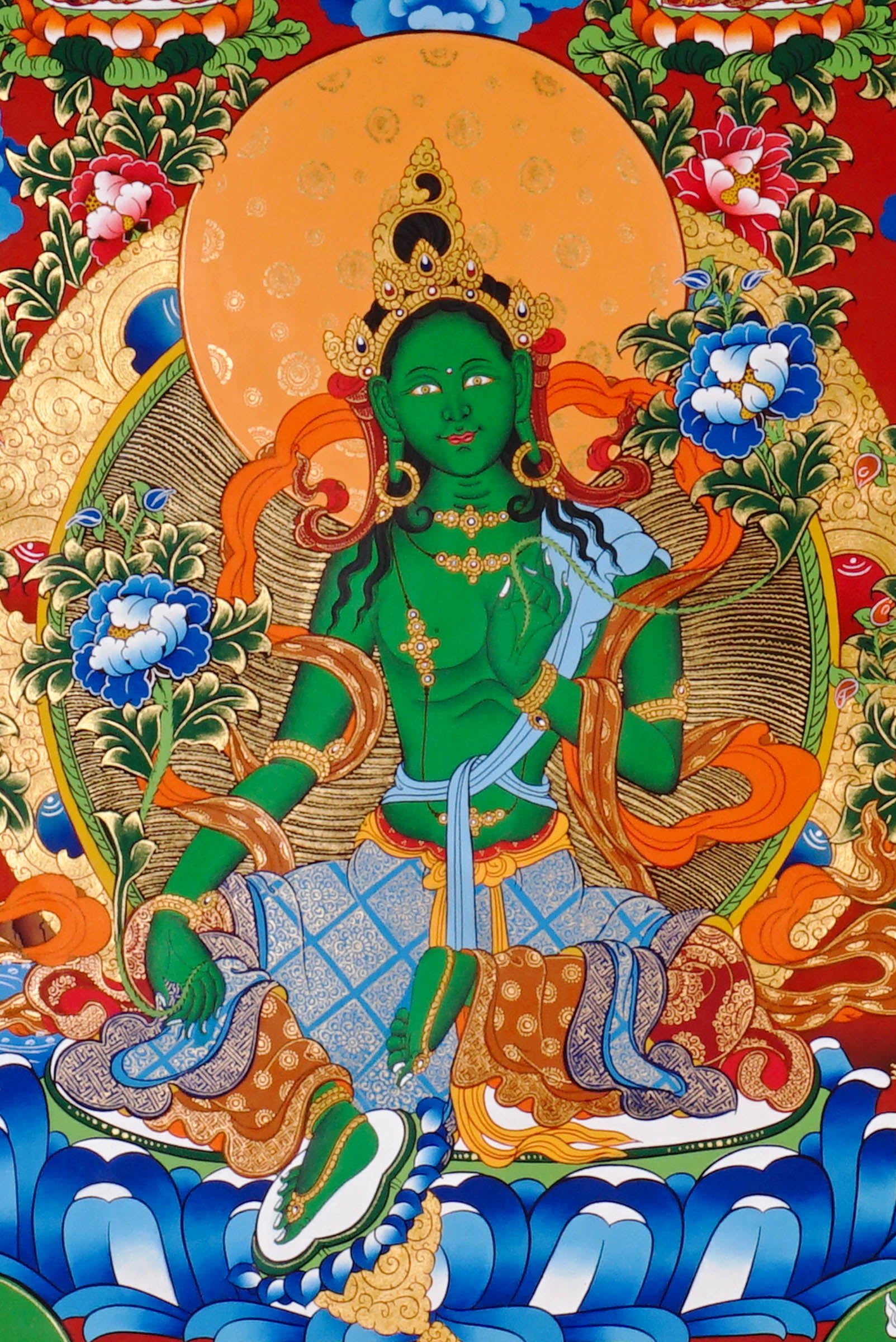 Green Tara Thangka painting with lotus throne, floral branches, celestial Buddhas, and Tibetan Buddhist compassion symbolism.