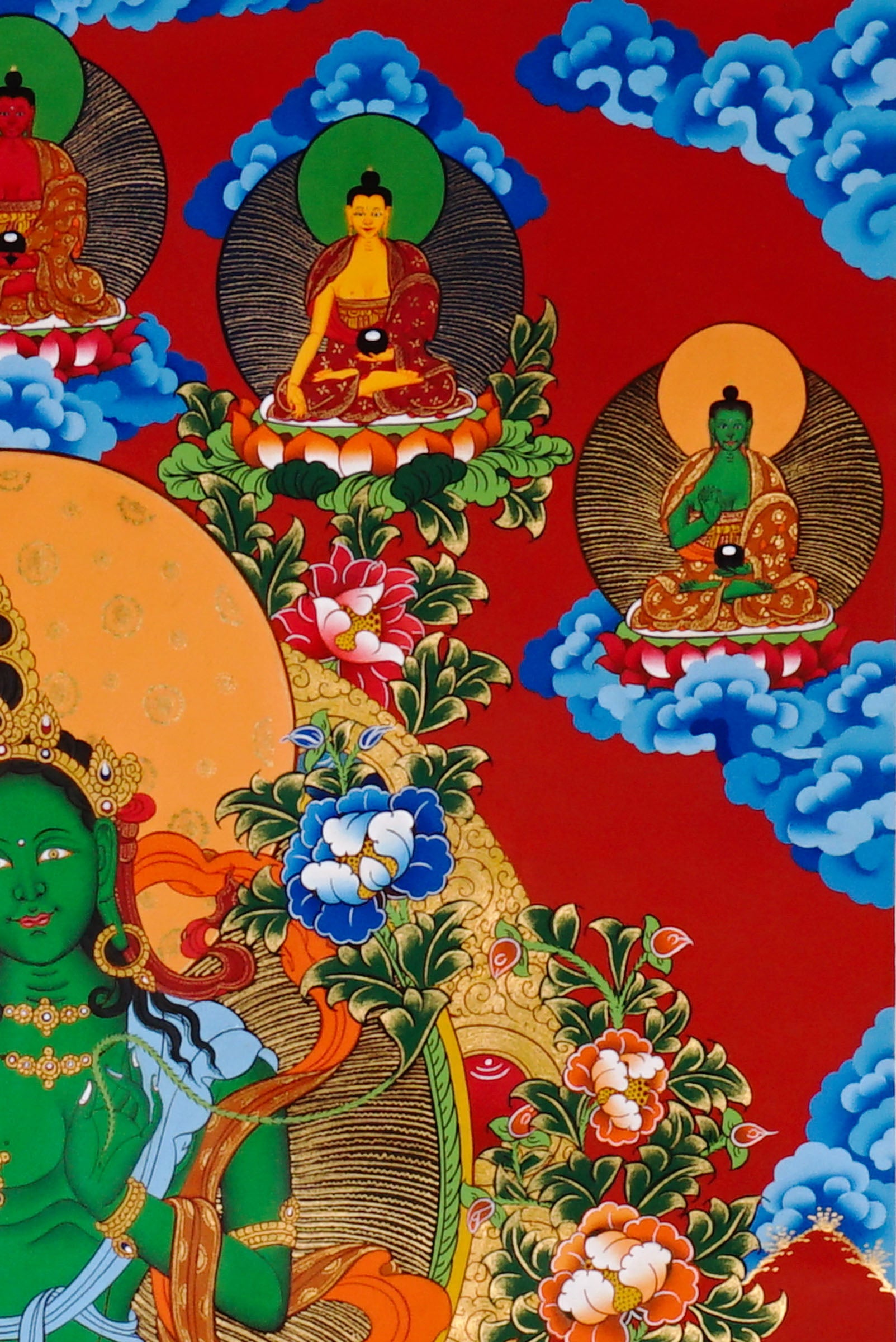 Green Tara Thangka painting with lotus throne, floral branches, celestial Buddhas, and Tibetan Buddhist compassion symbolism.