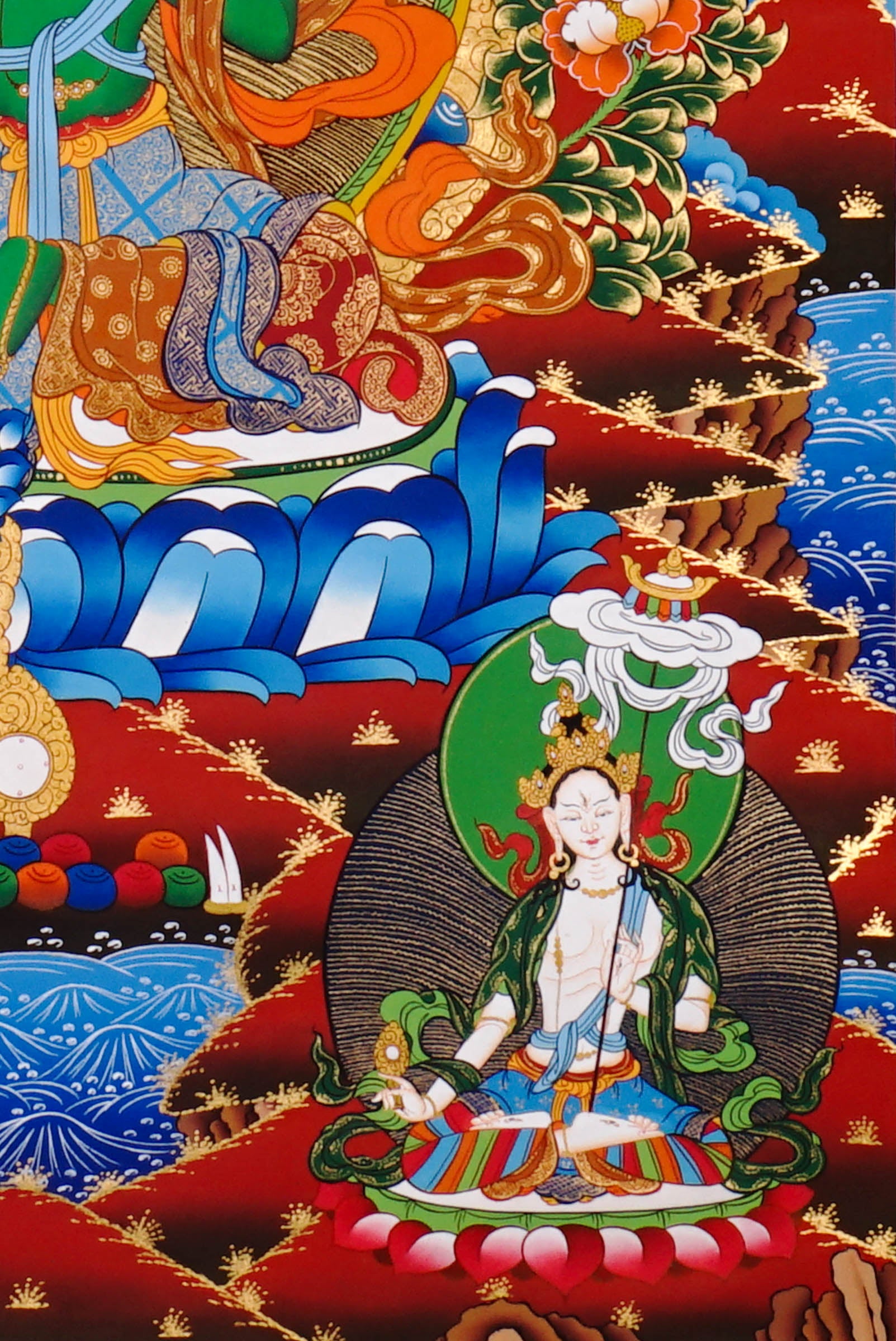 Green Tara Thangka painting with lotus throne, floral branches, celestial Buddhas, and Tibetan Buddhist compassion symbolism.