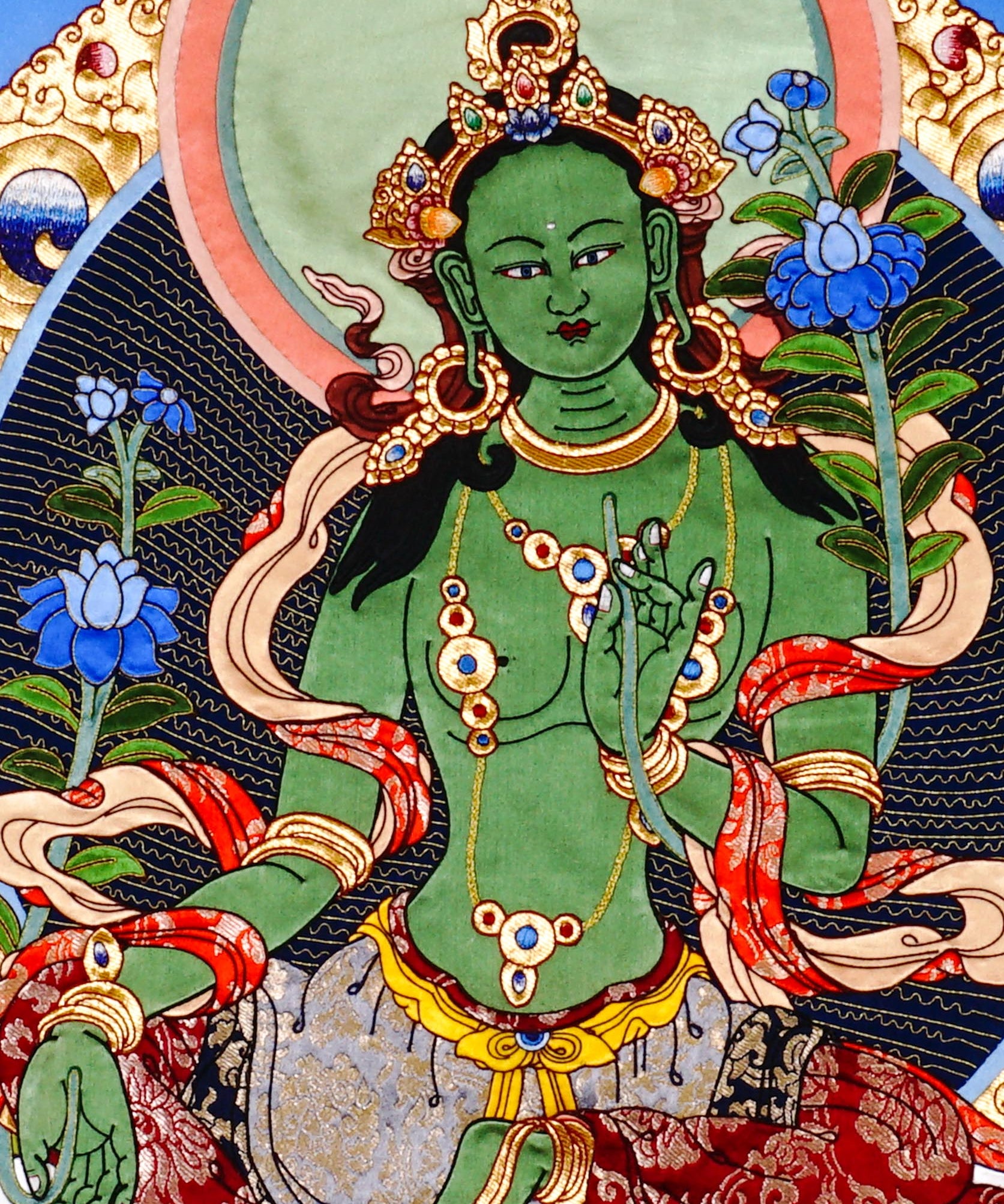 Green Tara thangka painting Tibetan goddess seated on lotus holding blue lotus in detailed traditional composition