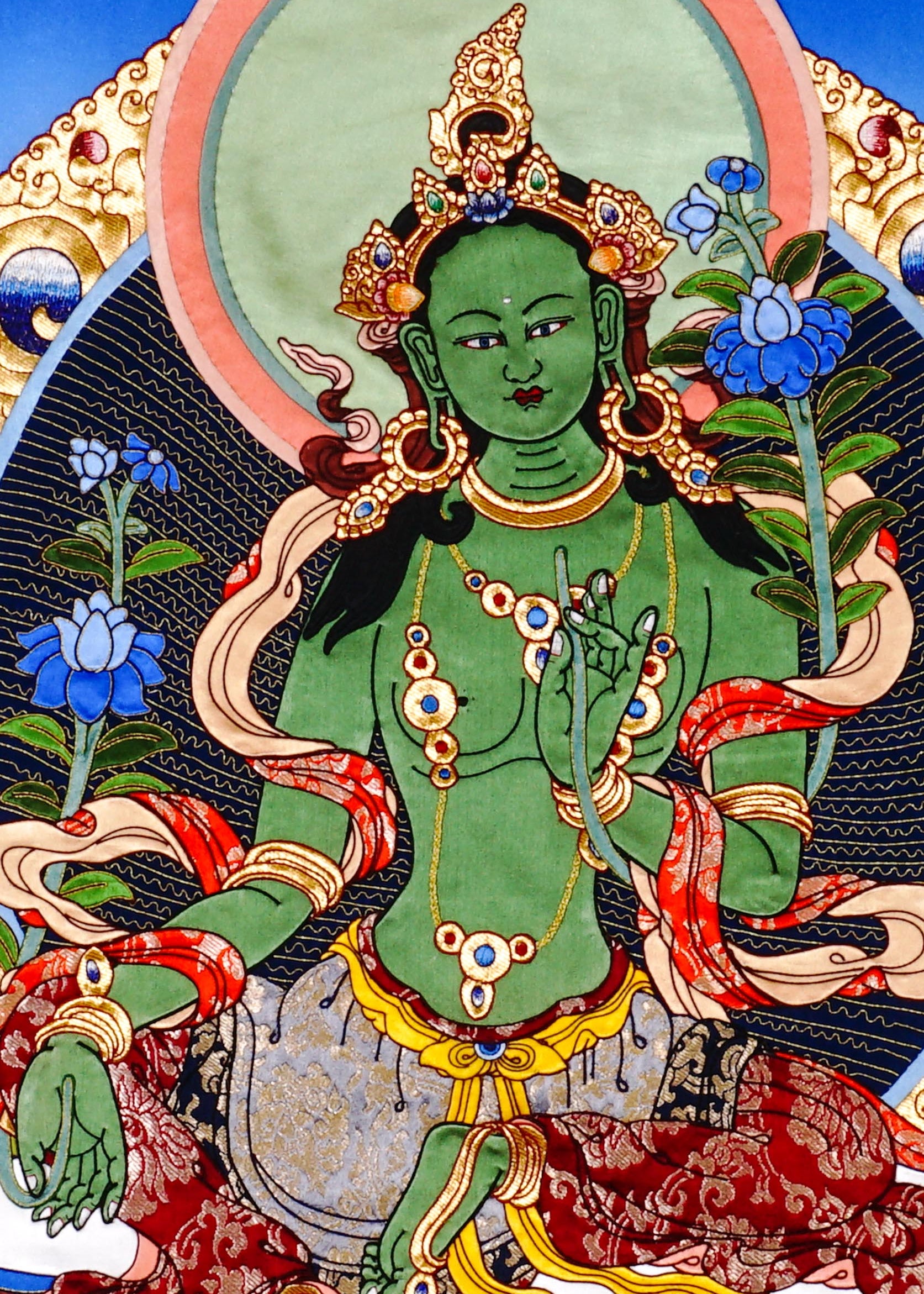 Green Tara thangka painting Tibetan goddess seated on lotus holding blue lotus in detailed traditional composition