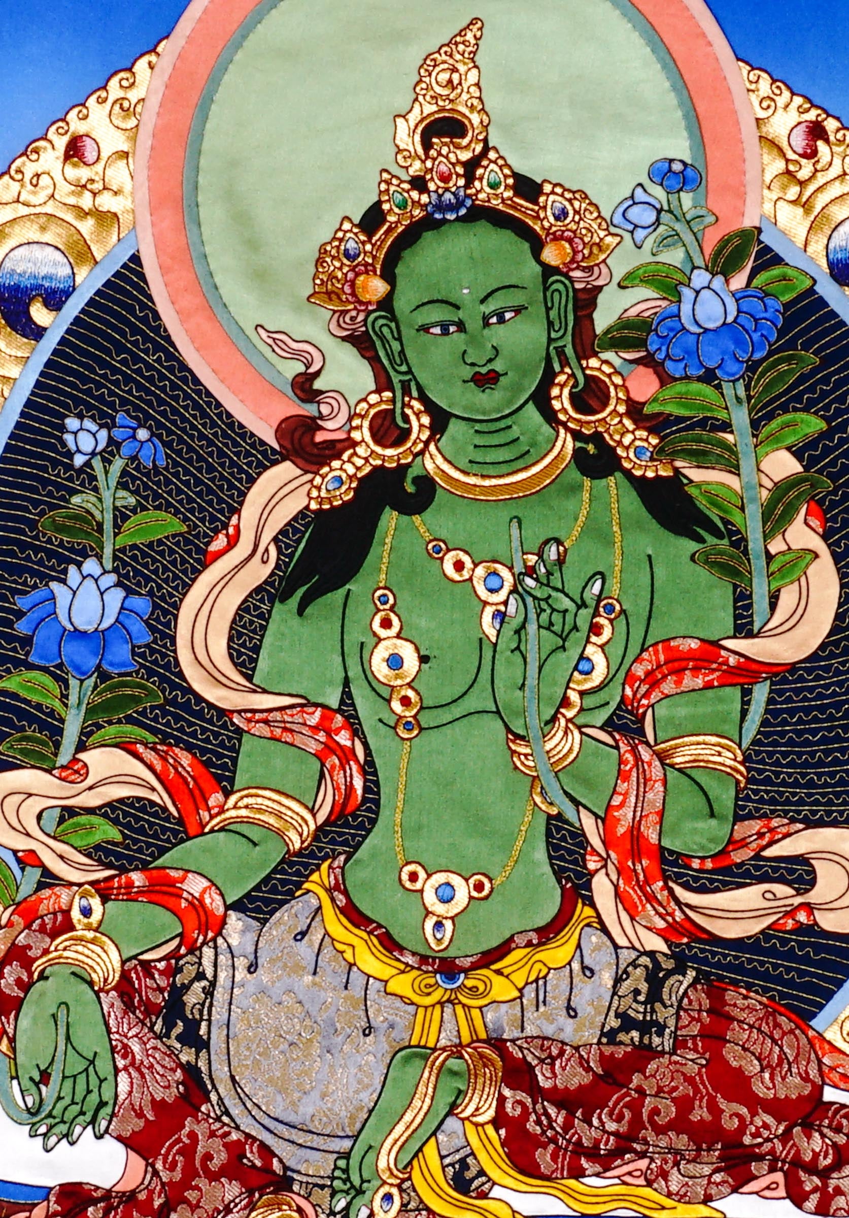 Green Tara thangka painting Tibetan goddess seated on lotus holding blue lotus in detailed traditional composition