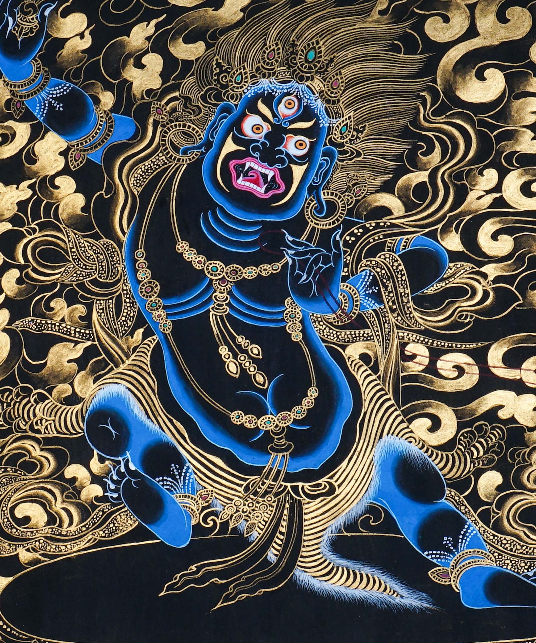 Vajrapani Thangka Painting showing a wrathful Tibetan Buddhist protector deity with multiple faces and arms, ritual implements, gold cloud patterns, flame-like details, lotus base and Himalayan landscape elements