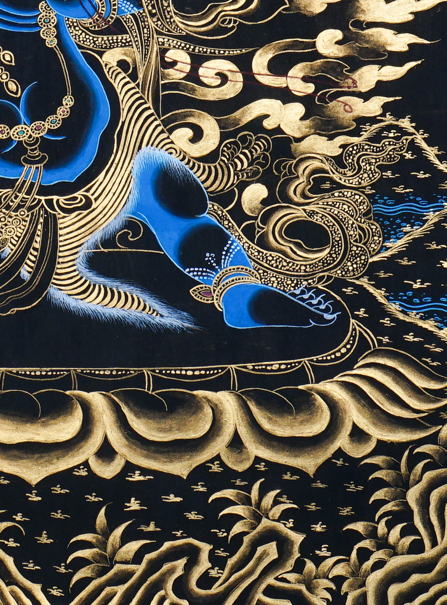 Vajrapani Thangka Painting showing a wrathful Tibetan Buddhist protector deity with multiple faces and arms, ritual implements, gold cloud patterns, flame-like details, lotus base and Himalayan landscape elements