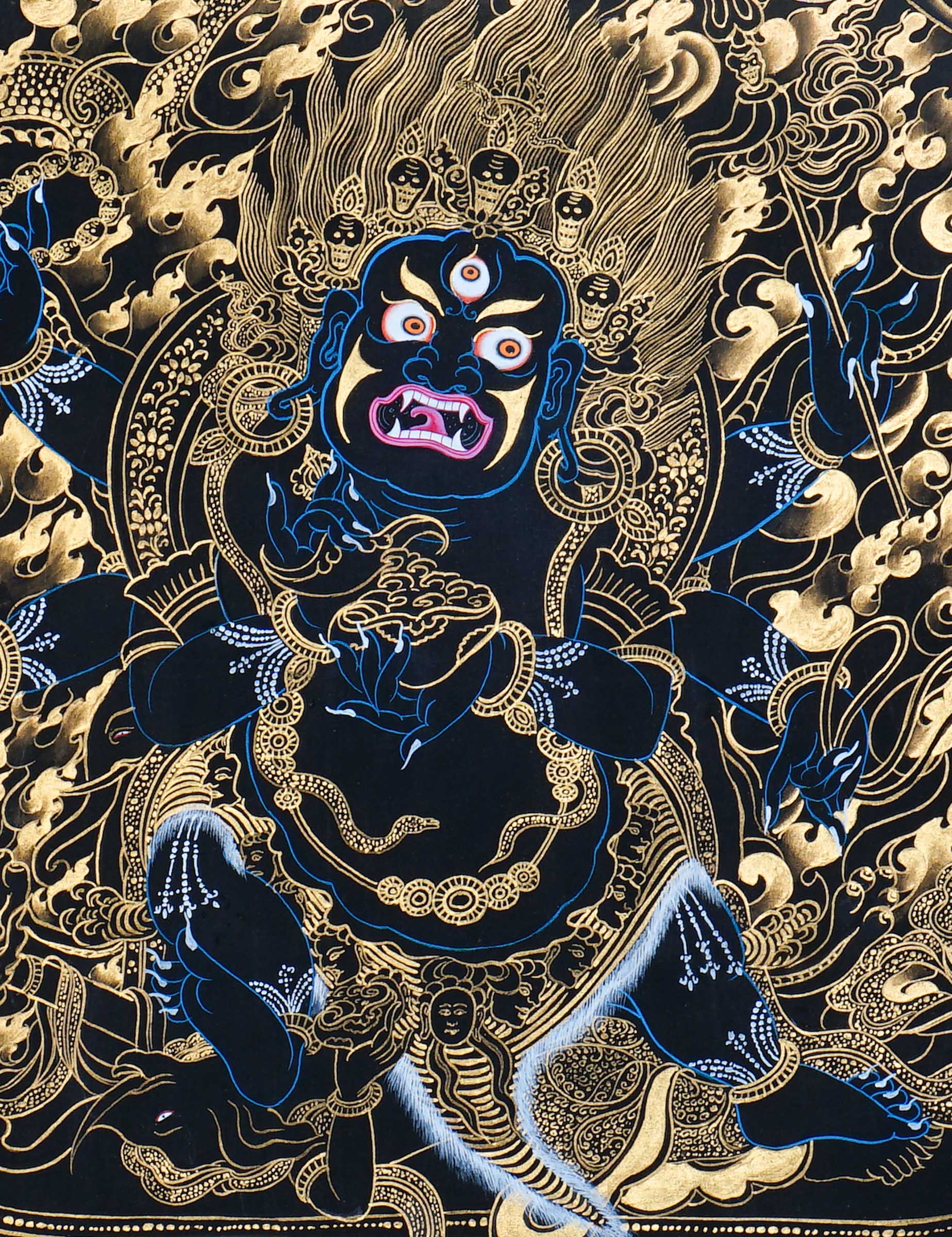 Mahakala thangka painting showing a wrathful blue Mahakala deity with multiple arms, flaming aura, gold clouds, dragon motif, and black background in traditional Tibetan Buddhist style.