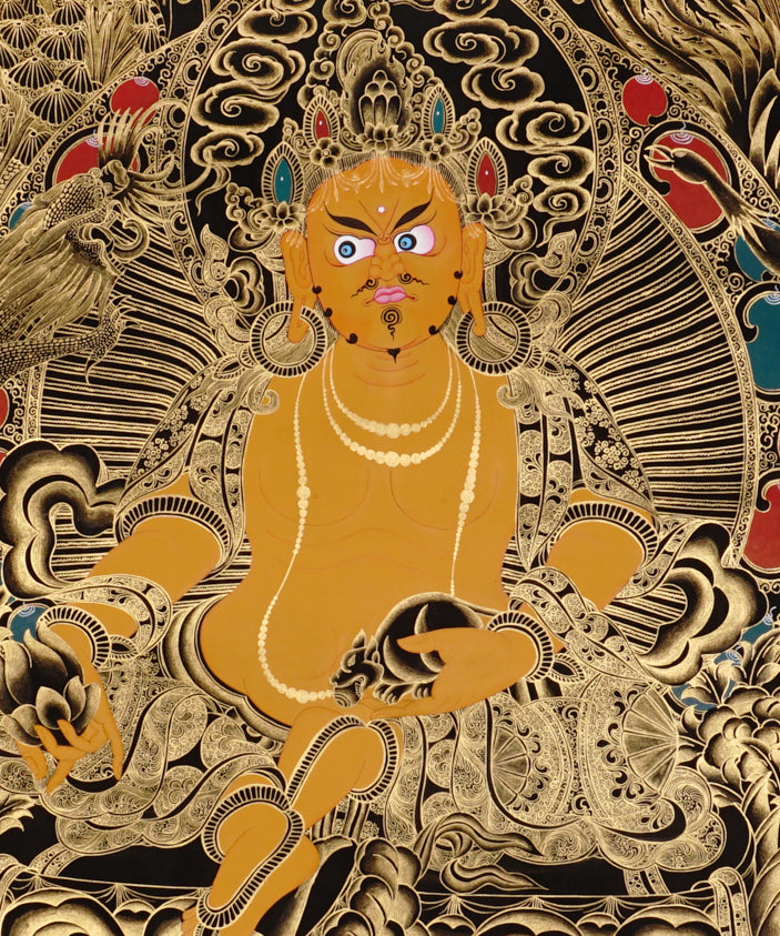 Yellow Zambhala Thangka painting with gold detailing, lotus throne, symbolic birds, and Tibetan Buddhist prosperity symbolism.