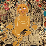Yellow Zambala Thangka painting with gold detailing, lotus throne, symbolic birds, and Tibetan Buddhist prosperity symbolism.