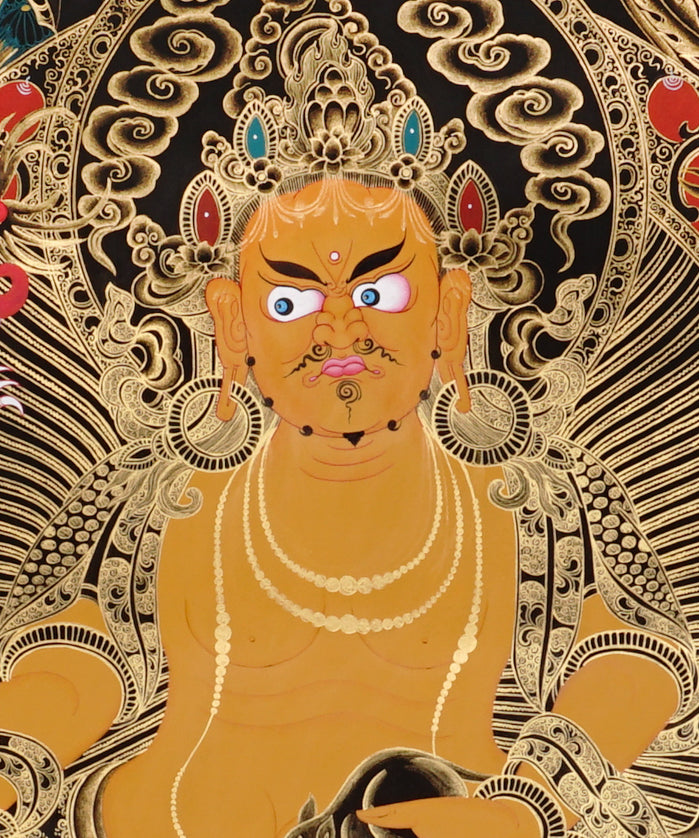 Yellow Zambala Thangka painting with gold detailing, lotus throne, symbolic birds, and Tibetan Buddhist prosperity symbolism.