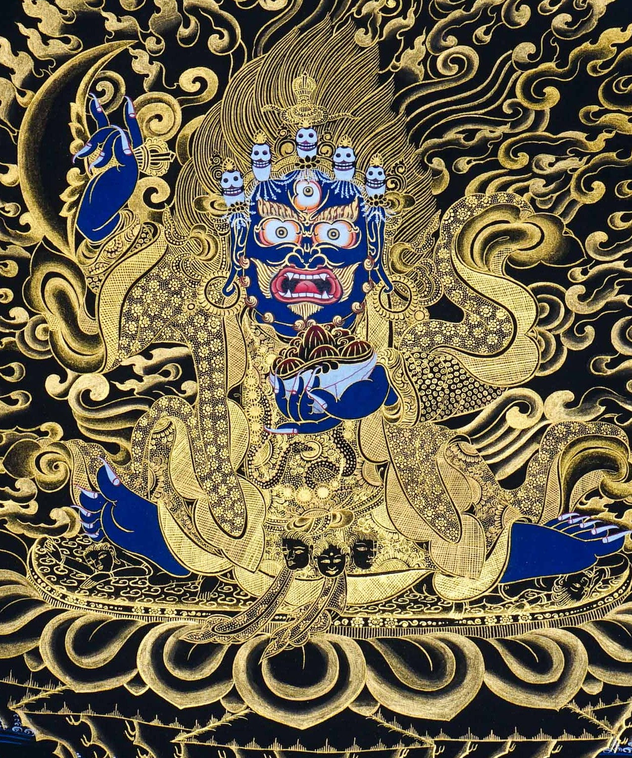 Kagyu Mahakal Thangka Painting showing a wrathful Tibetan Buddhist Dharma protector in black and gold style with blue details, skull crown, skull cup, flame aura, lotus base, gold clouds, lineage figure and Himalayan landscape.