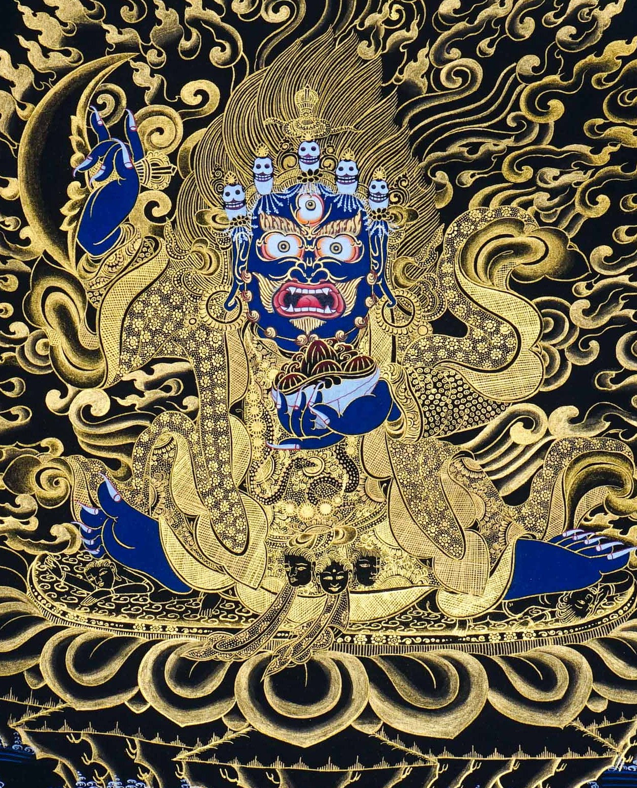 Kagyu Mahakal Thangka Painting showing a wrathful Tibetan Buddhist Dharma protector in black and gold style with blue details, skull crown, skull cup, flame aura, lotus base, gold clouds, lineage figure and Himalayan landscape.