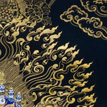 Kagyu Mahakal Thangka Painting showing a wrathful Tibetan Buddhist Dharma protector in black and gold style with blue details, skull crown, skull cup, flame aura, lotus base, gold clouds, lineage figure and Himalayan landscape.