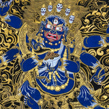 Close-up detail of Six Hand Mahakala Thangka Painting, six-armed wrathful protector in black, gold and blue with flame motifs and lotus base