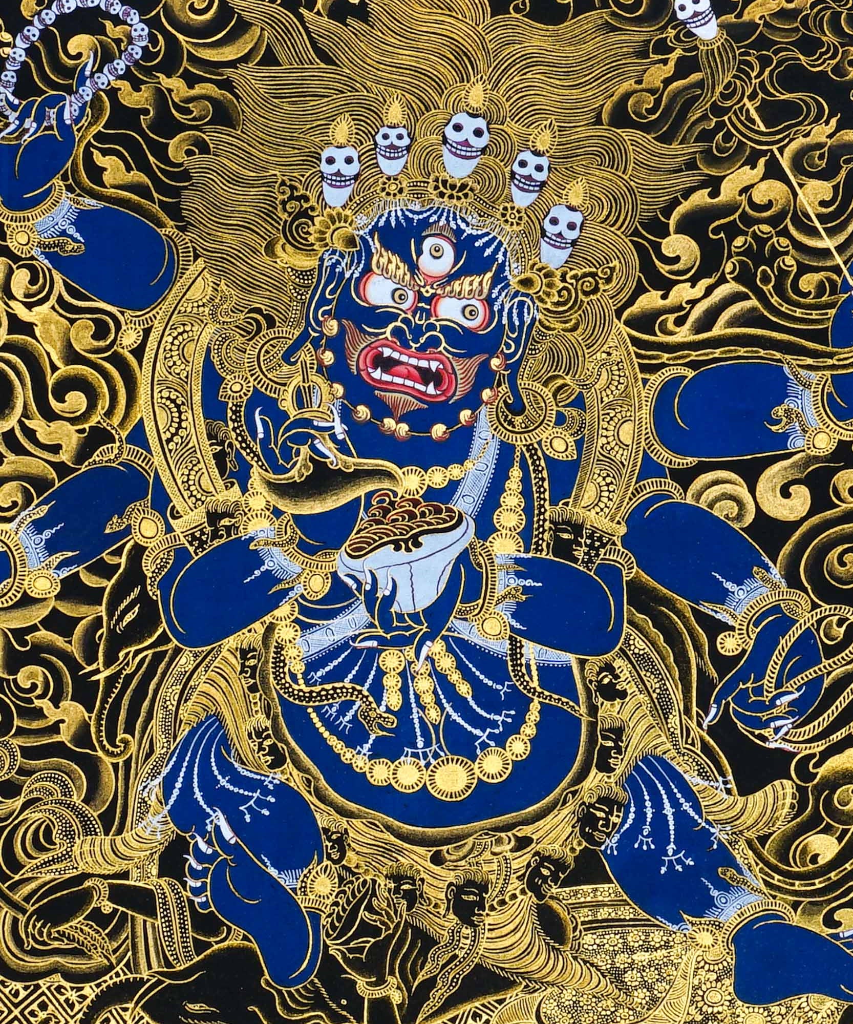 Close-up detail of Six Hand Mahakala Thangka Painting, six-armed wrathful protector in black, gold and blue with flame motifs and lotus base