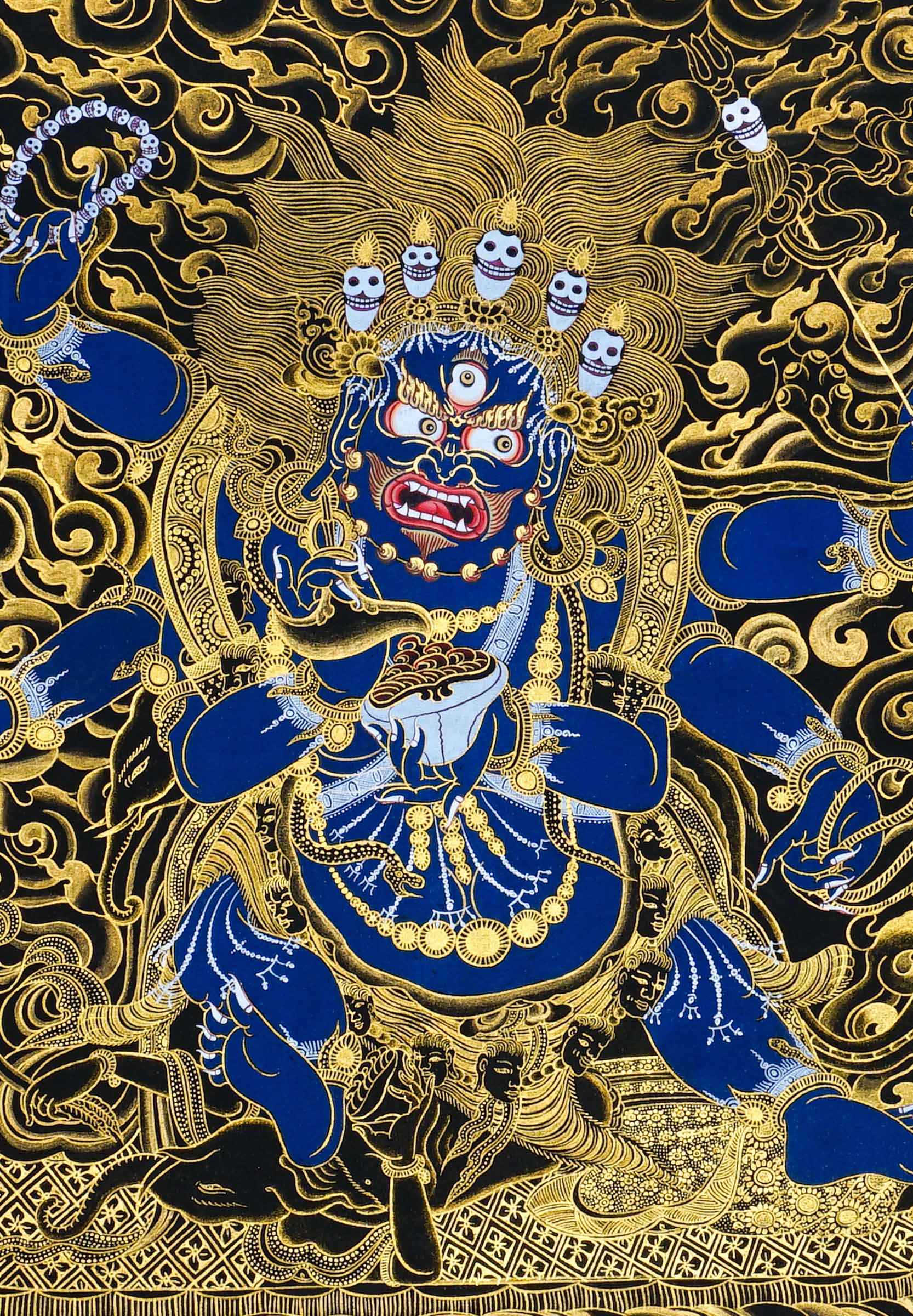 Close-up detail of Six Hand Mahakala Thangka Painting, six-armed wrathful protector in black, gold and blue with flame motifs and lotus base